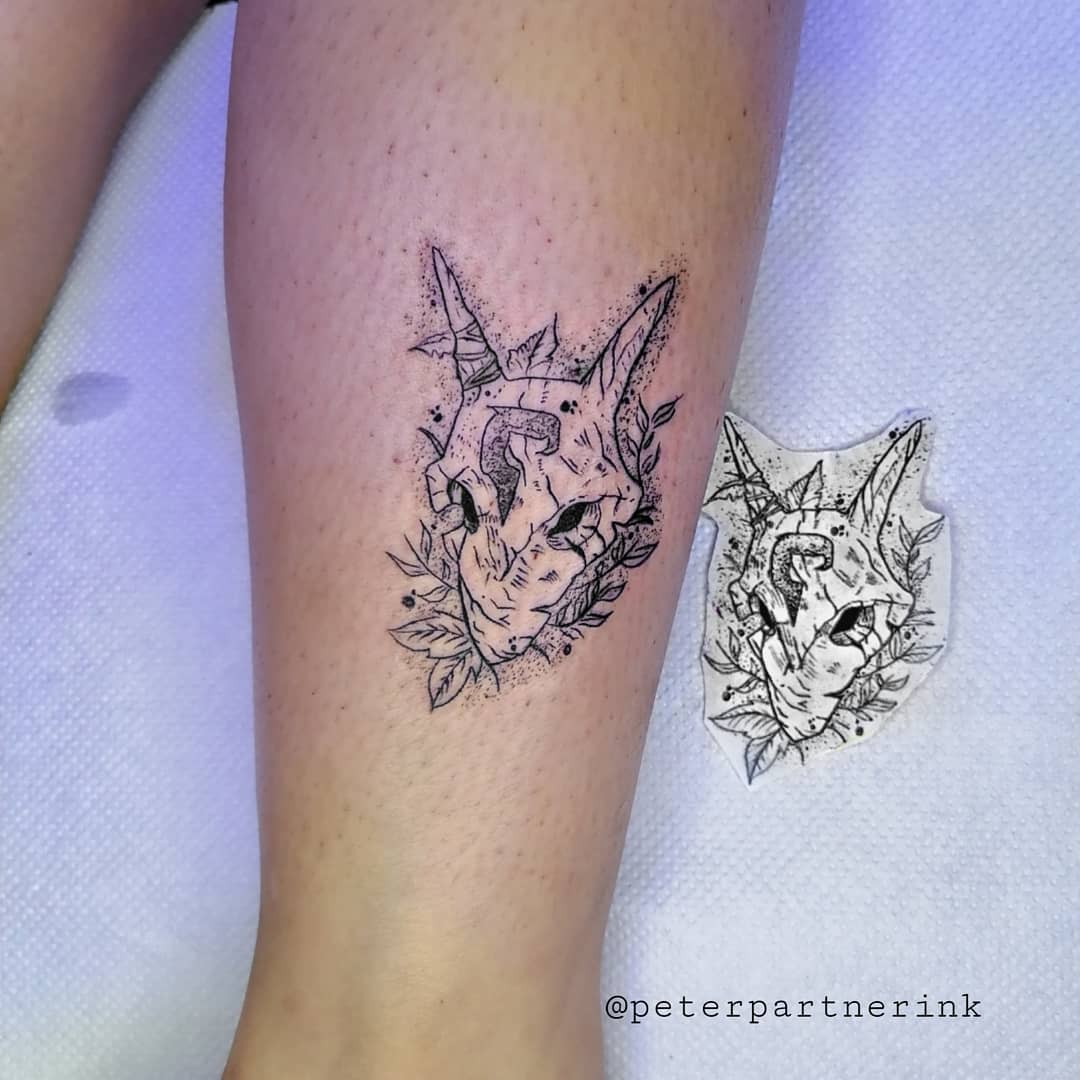 Black and white tattoo of Kindred's Wolf mask from League of Legends, adorned with leaves and intricate details