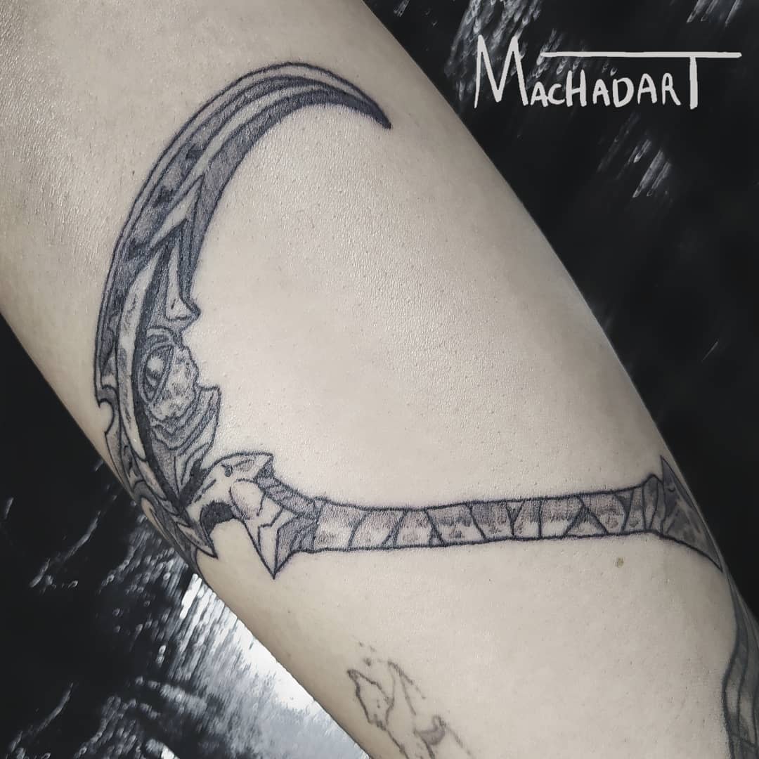 Black and white tattoo of Kayn’s scythe from League of Legends, with intricate details on the blade