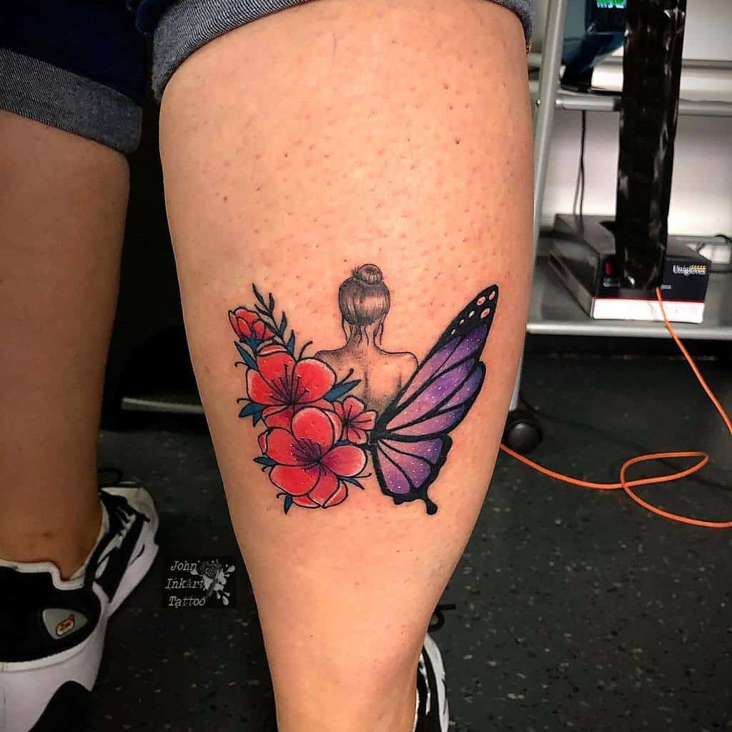 Tattoo of a woman with flowers and a butterfly wing on the back of a calf