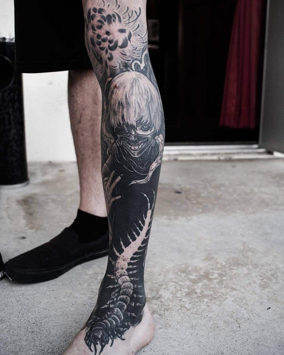 Full leg tattoo of Kaneki Ken from Tokyo Ghoul, featuring detailed black and white shading with a centipede design wrapping around the leg