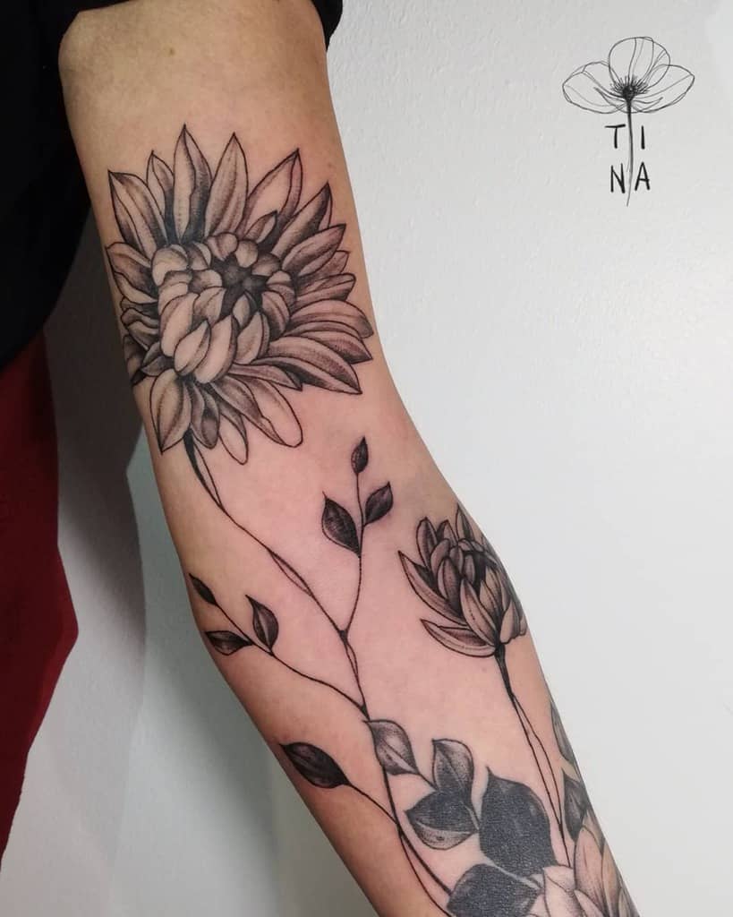 A stunning sleeve featuring a detailed flower with leaves, all in elegant black and gray ink