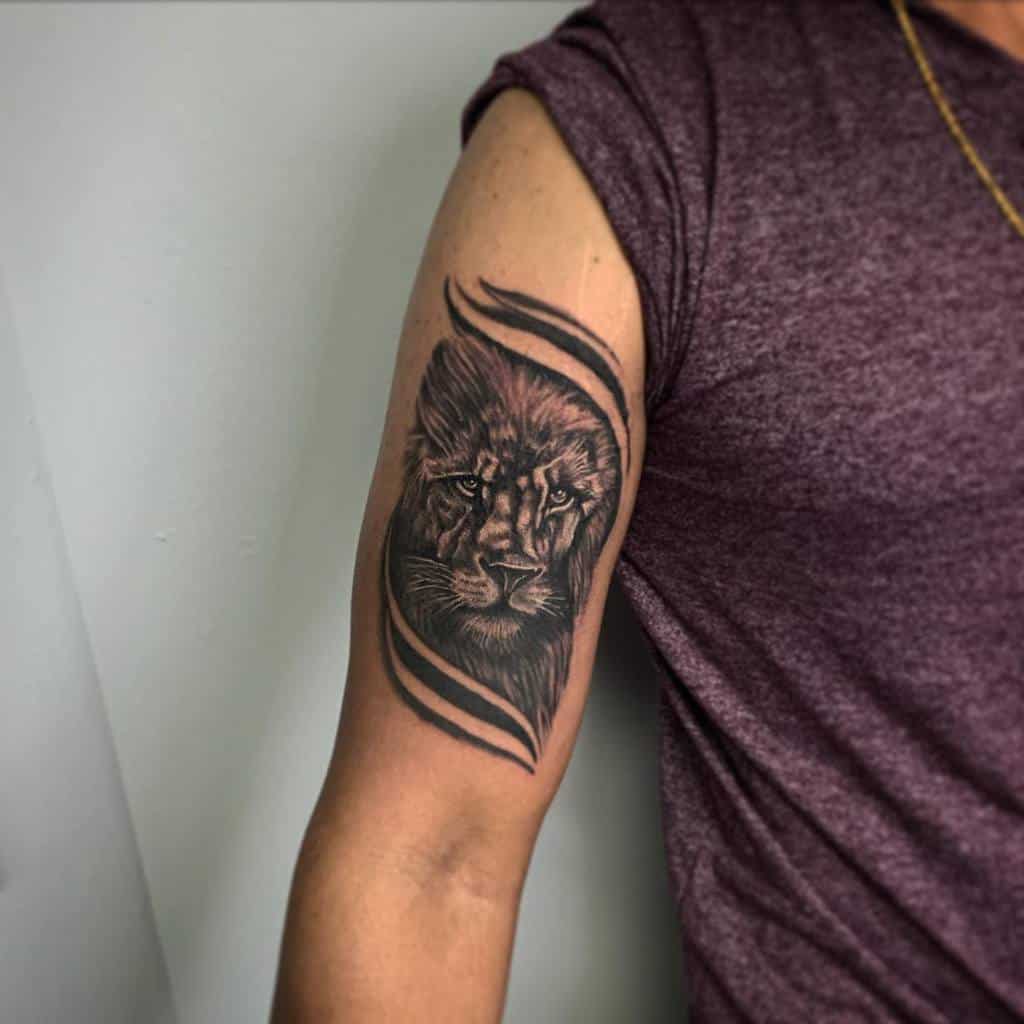 Arm with a lion tattoo, surrounded by abstract lines