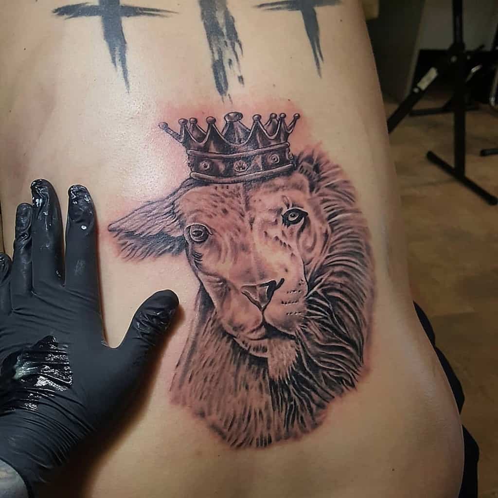 A tattoo of a crowned lion on a person's back, with a delicate lamb beneath it