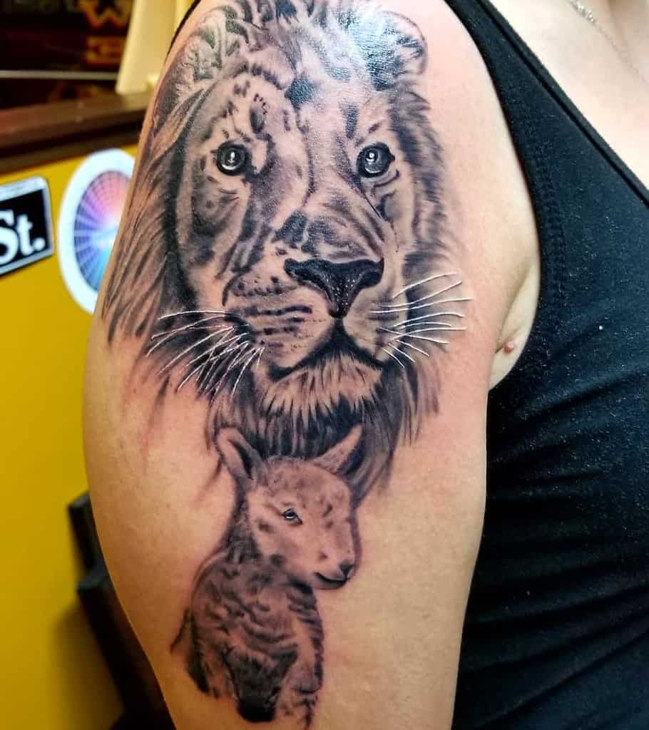 A detailed tattoo featuring a majestic lion and a gentle lamb gracefully adorns a person's upper arm
