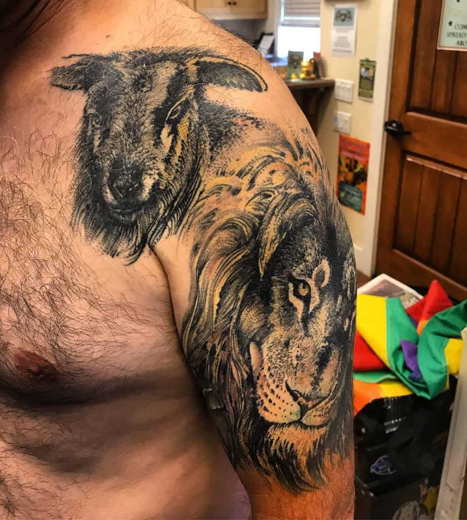 Tattoo of a lion and a lamb on a person's upper arm and shoulder