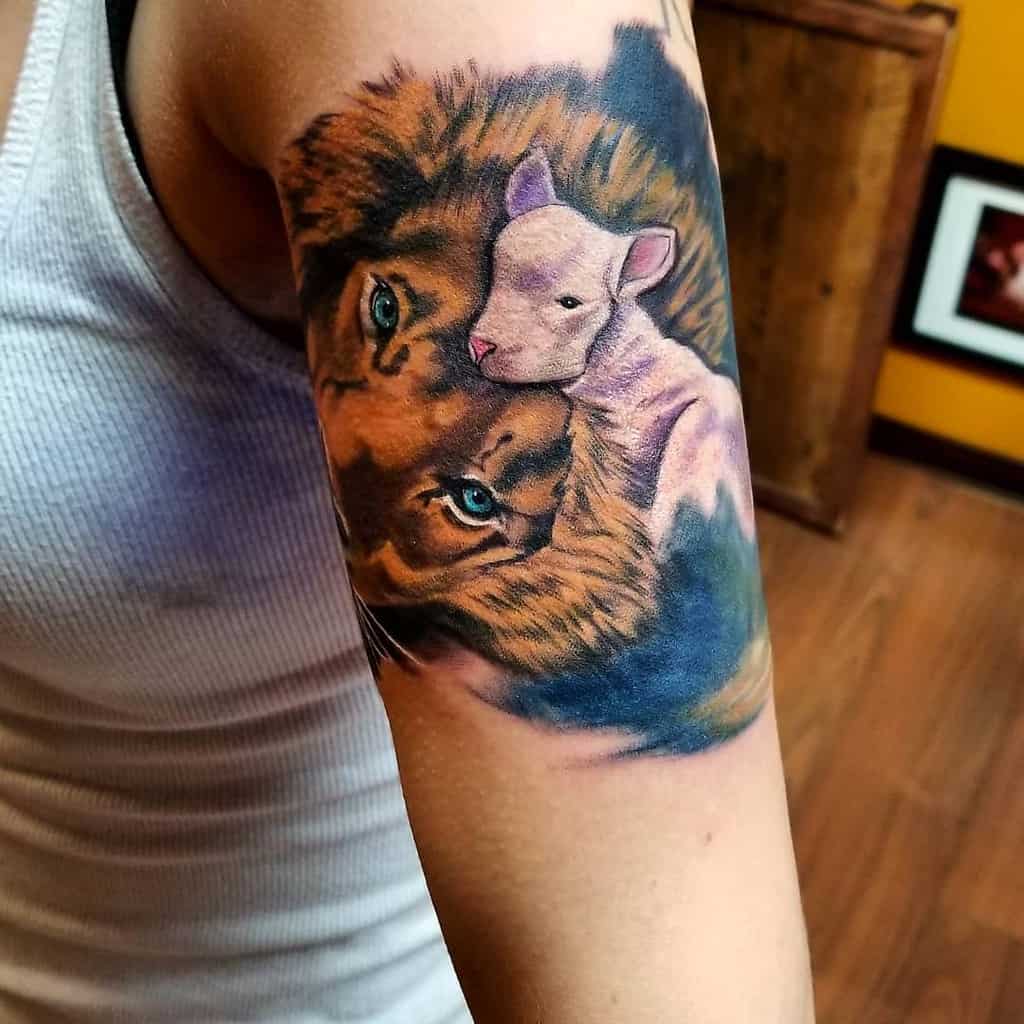 Lion and lamb tattoo on a person's upper arm, beautifully rendered in vibrant colors