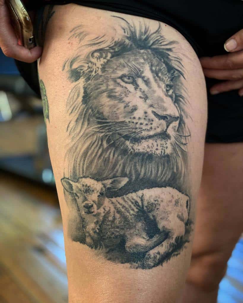 Tattoo of a majestic lion and gentle lamb on the thigh of a person wearing black shorts