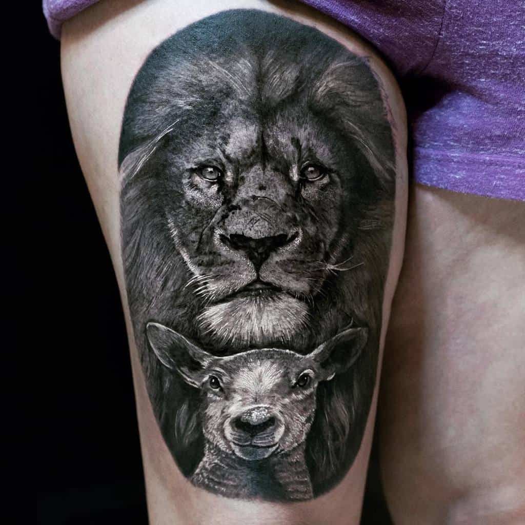 Tattoo of a lion's head above a lamb's head on a person's thigh