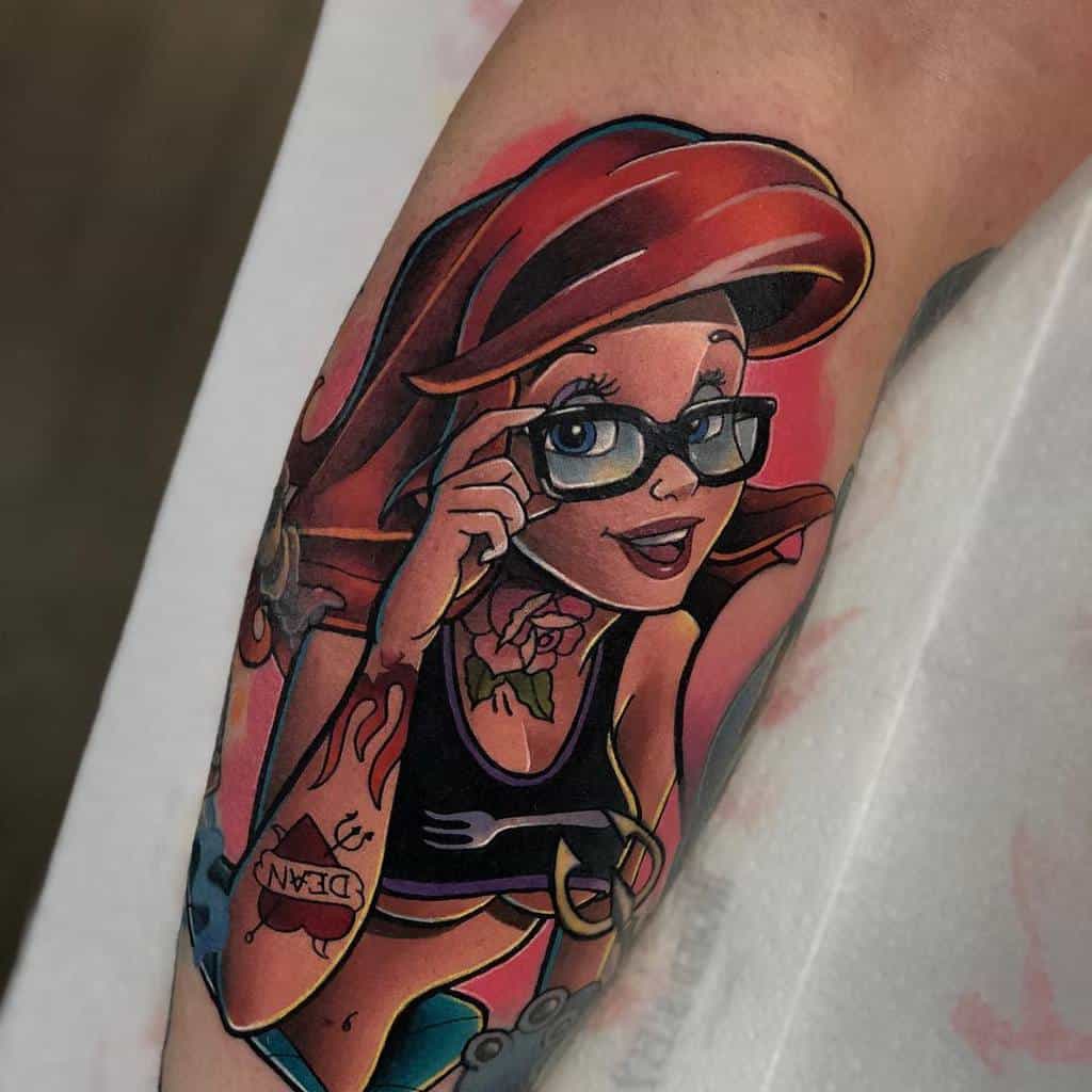 Modern Ariel tattoo with glasses, red hair, and edgy details like a fork tattoo and floral designs, adding a unique twist to the character