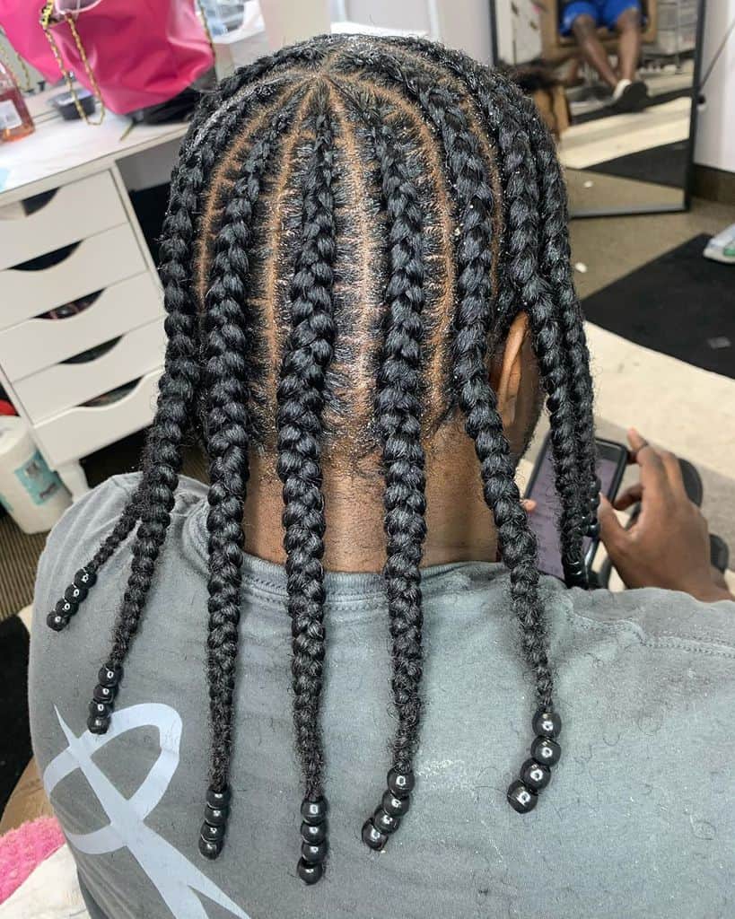 Long And Thick Braids Falling On The Shoulders. An Ideal Style For Guys With Long Hair