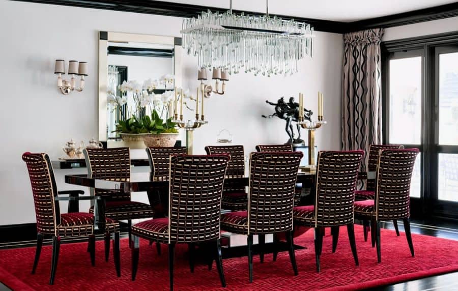 glass chandelier long dining room table and pattern fabric chairs red floor rug