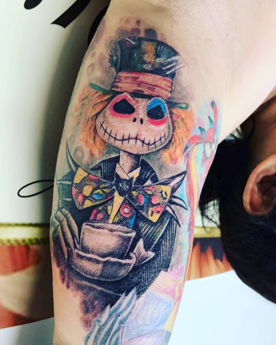 Creative tattoo of Jack Skellington as the Mad Hatter, merging characters from two iconic films in a vibrant design