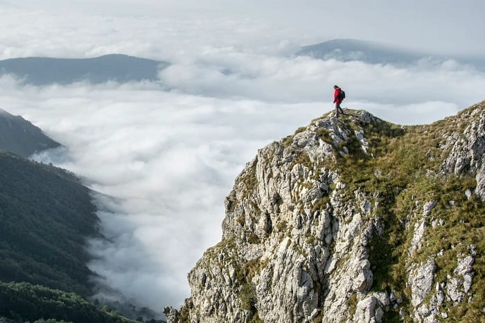 Man Standing On Mountain