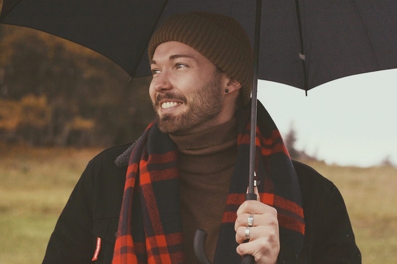 Man With Scarf And Umbrella In Fall Weather