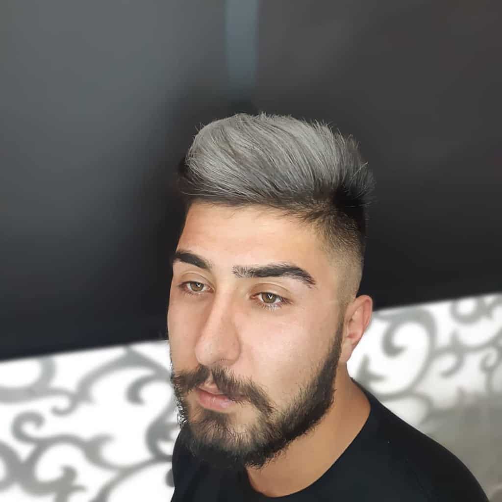 Man with blond highlights and dark facial hair-shahryar.aria