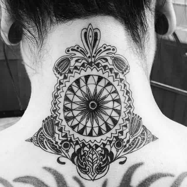 Ornate black ink tattoo with mandala and floral patterns artistically adorns the back of neck