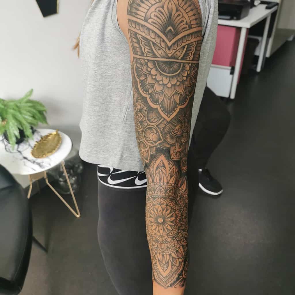 Arm with intricate mandala tattoo sleeve