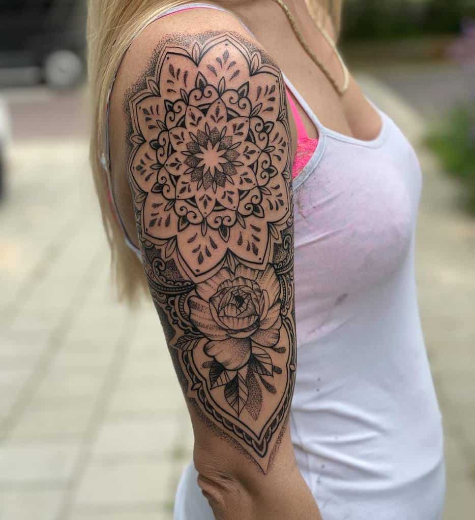 Woman with detailed mandala and flower shoulder tattoo