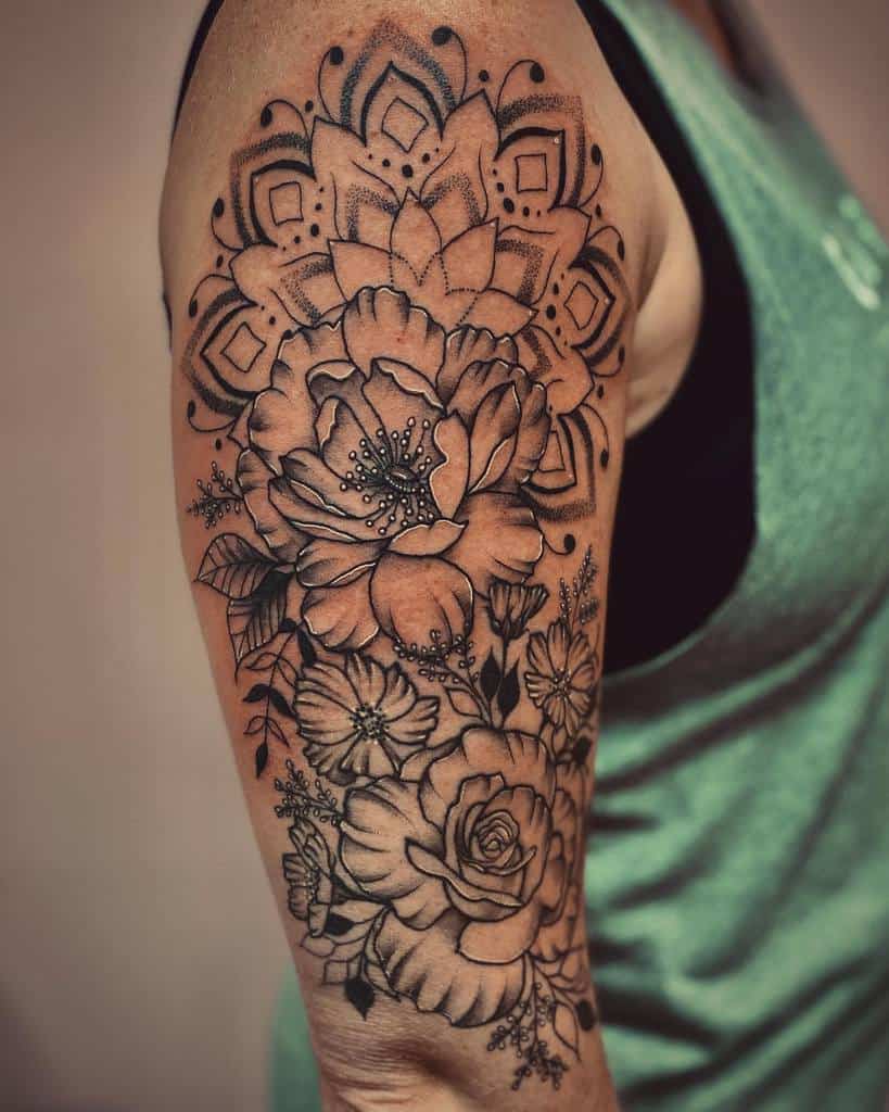 Floral and mandala arm tattoo featuring roses and intricate patterns