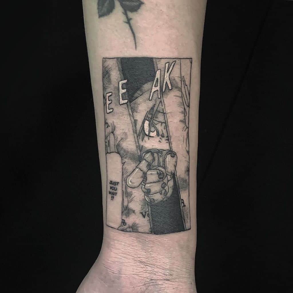 Fullmetal Alchemist tattoo of Edward Elric’s automail hand gripping, with the manga panel text "Just you wait!!" and "EEAK" sound effect