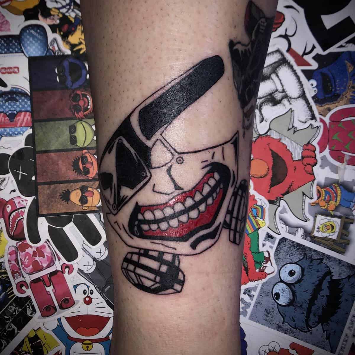 Forearm tattoo of Kaneki Ken's ghoul mask from Tokyo Ghoul, with bold black and red details