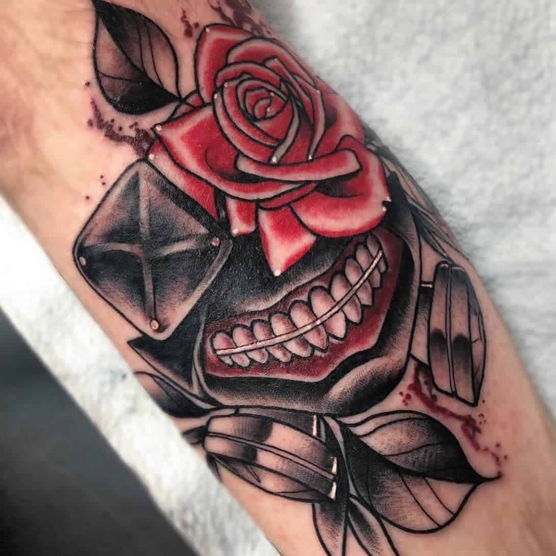 Arm tattoo of Kaneki Ken's ghoul mask from Tokyo Ghoul, featuring a detailed red rose and black leaves
