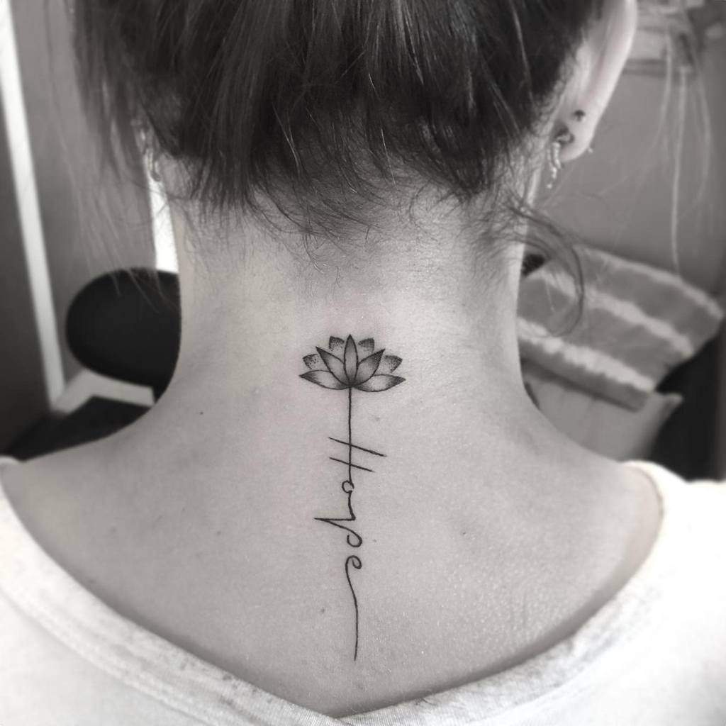 A lotus flower tattoo on the back of a person's neck with the word "hope" written vertically below it