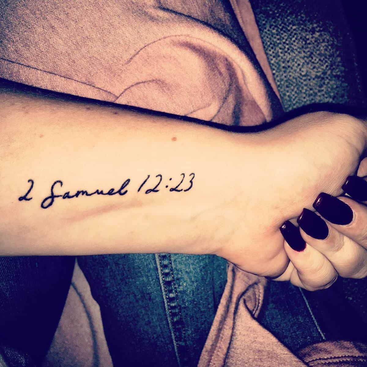 A wrist tattoo of "2 Samuel 12:23" in handwritten script