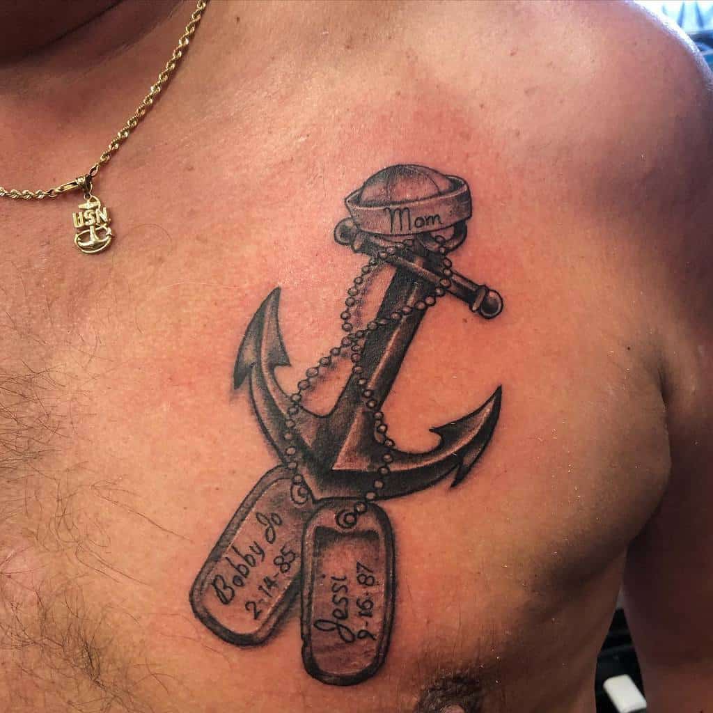 Navy anchor tattoo with "Mom" banner and dog tags reading "Bobby Jo 2-1-85" and "Jessi 5-16-87"