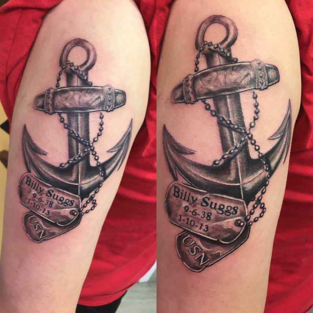 Tattoo of a navy anchor with etched text on a person's arm