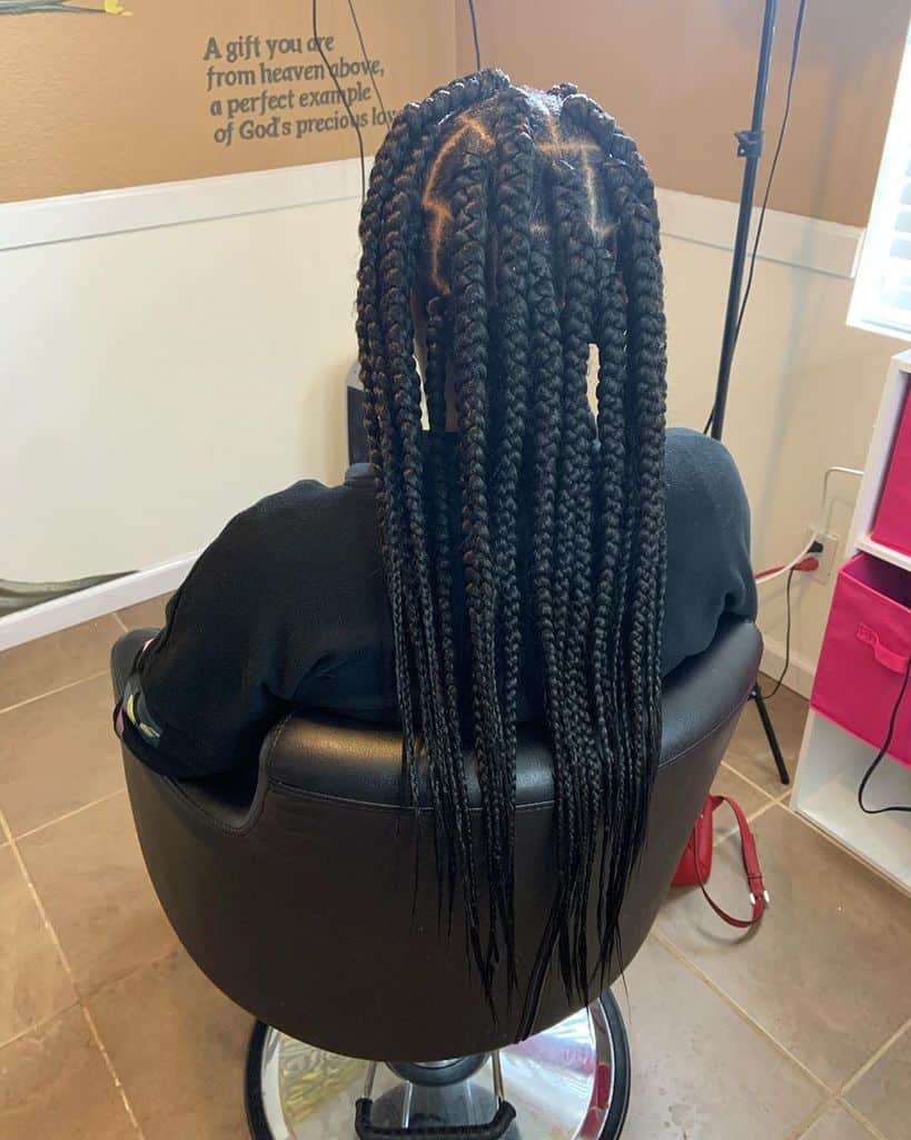Men’s Box Braids And Long Braided Hair Held At The Top With An Elastic Band