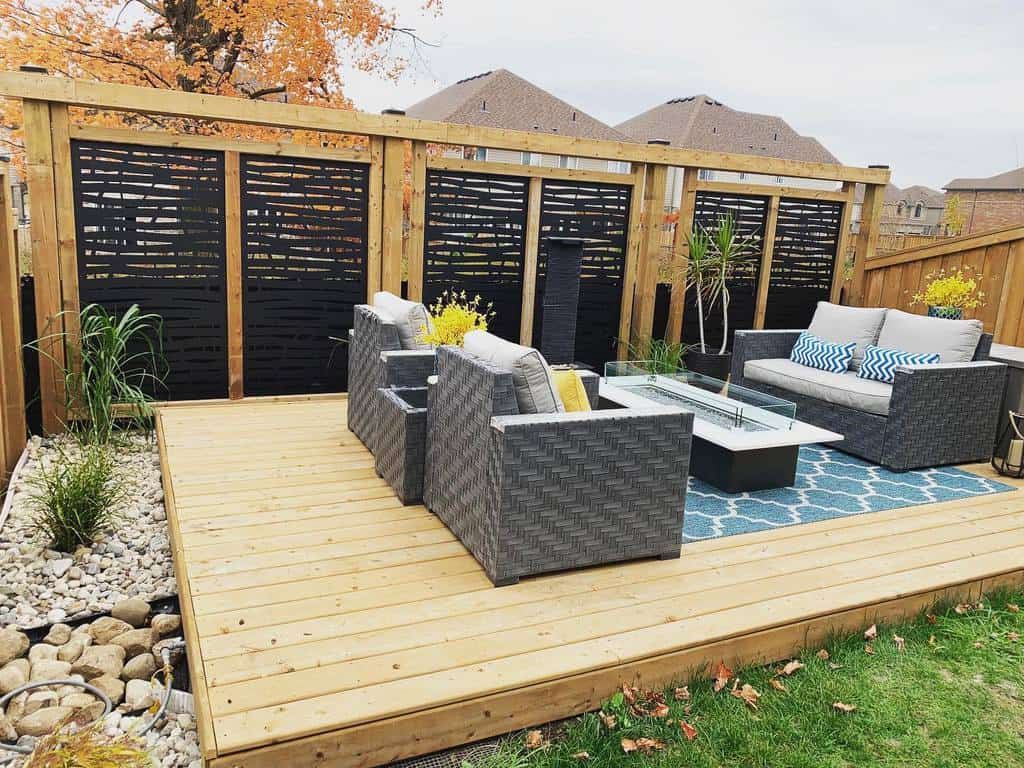 wood deck gray wicker sofa and chairs wood privacy fence