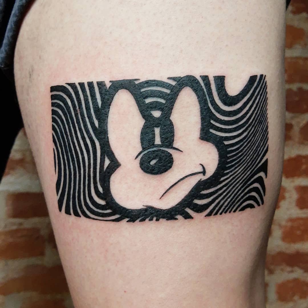 Abstract black-and-white tattoo of a distorted Mickey Mouse face with wavy line patterns