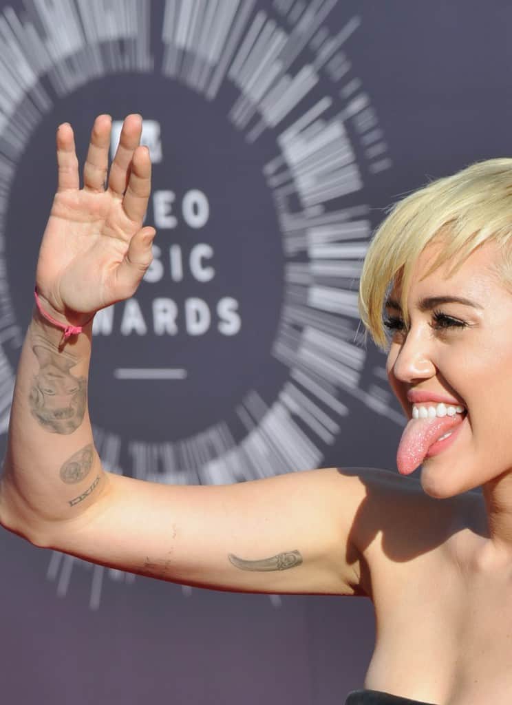 Miley Tongue Out Hand Up Can See Grandmother Tattoo