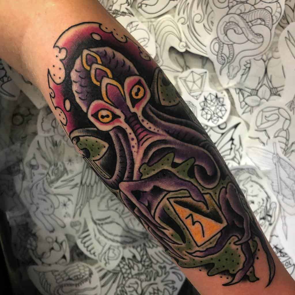 Vibrant Dungeons & Dragons tattoo of a Mind Flayer with piercing yellow eyes, swirling tentacles, and a glowing d20 die in its grasp