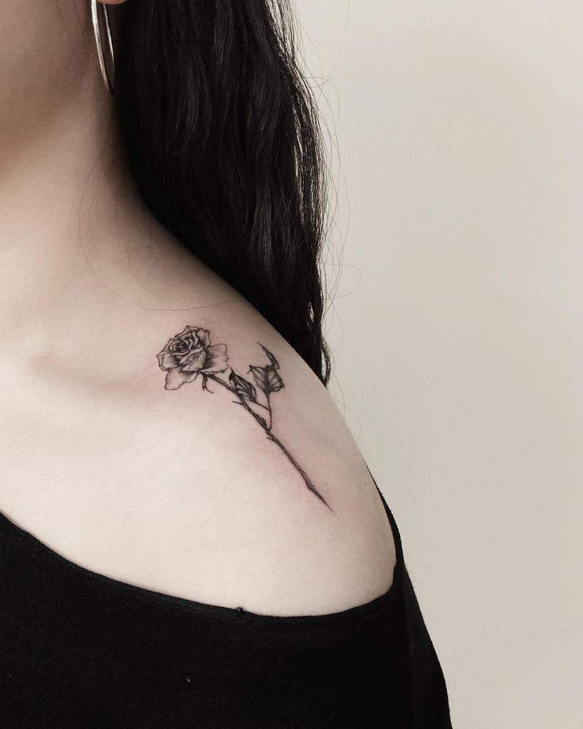 A black rose tattoo on a shoulder