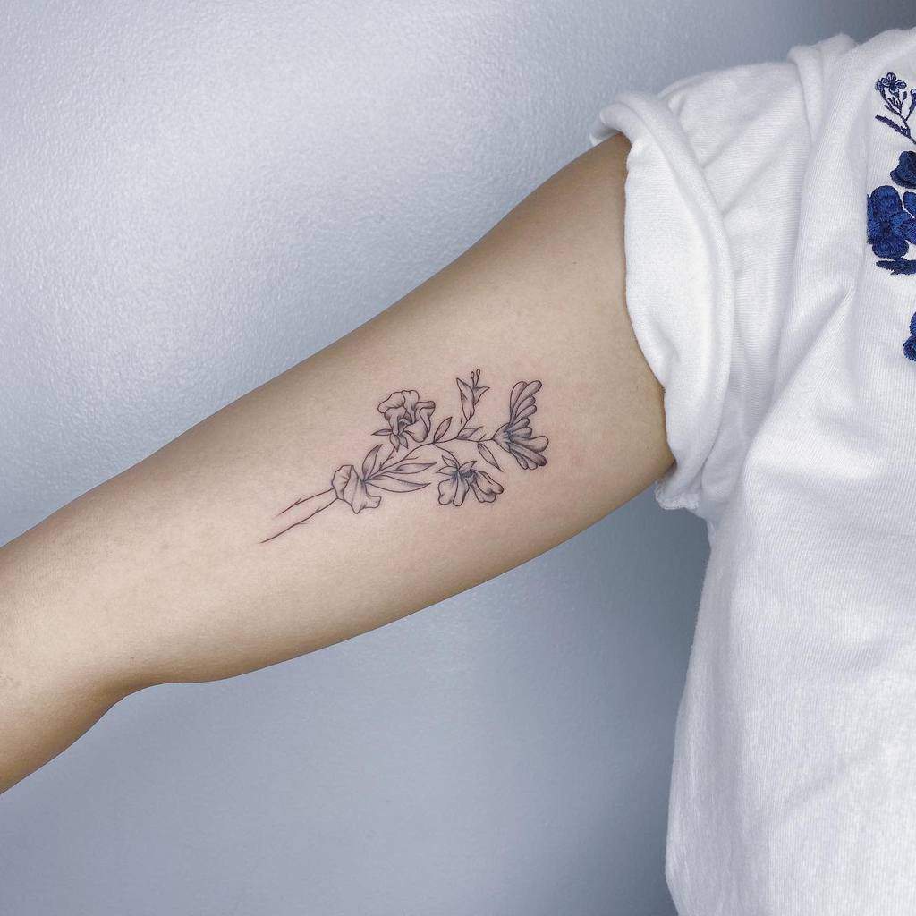 Tattoo of a floral design on a person's upper arm