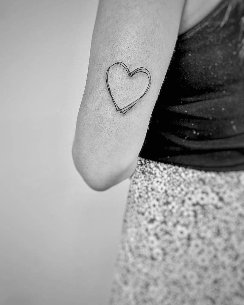 Minimalist double-line heart tattoo in a chic black ink design with a modern touch