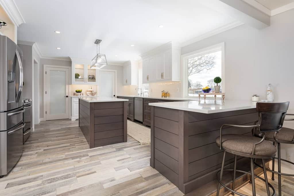 natural wood and white colored cabinets large kitchen breakfast bar island vinyl wood flooring