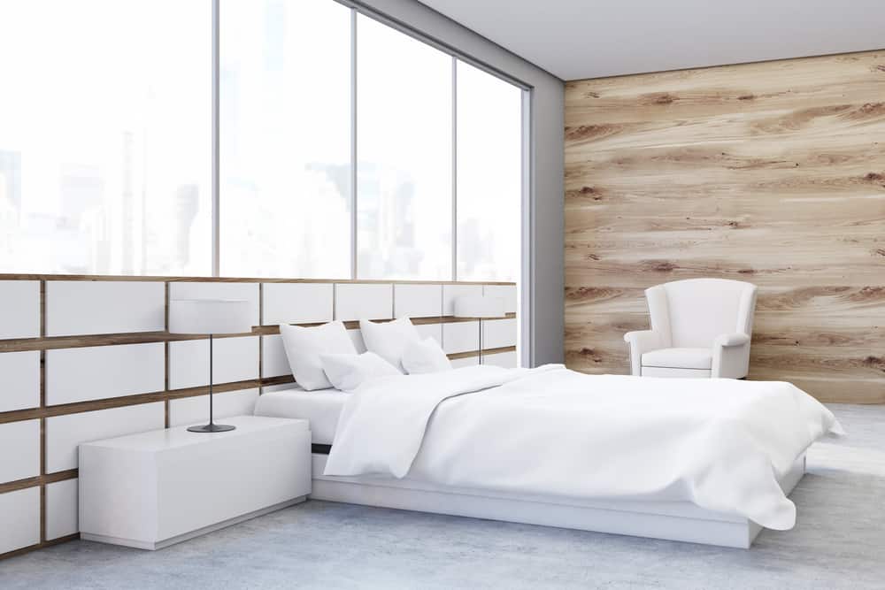 wood panel accent wall in white apartment bedroom