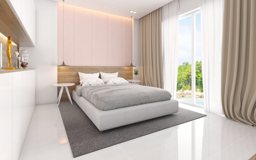 white bedroom with platform bed with pink accent wall
