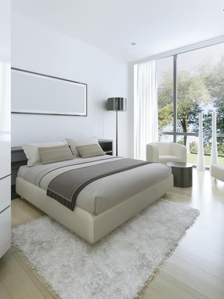 modern minimalist bedroom with sofa chairs