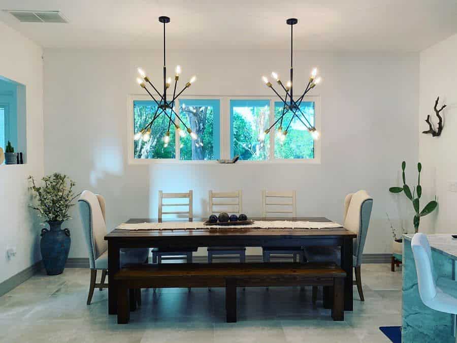 large dining room table gray slate floor sputnik chandeliers