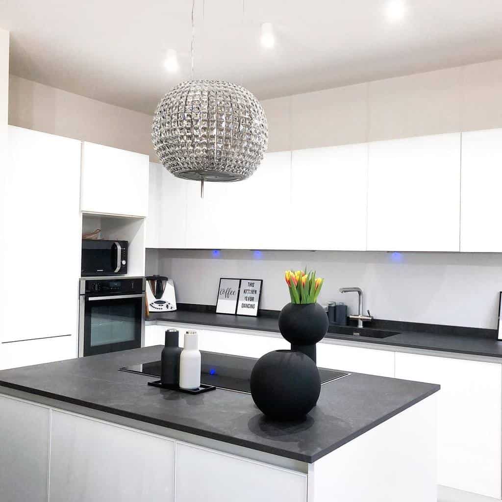 modern kitchen white cabinets black countertop unique chandelier