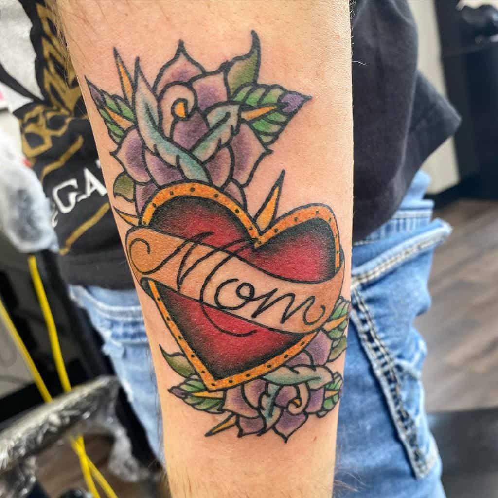 A tattoo with a heart, the word "Mom," and vibrant purple roses graces a person's forearm