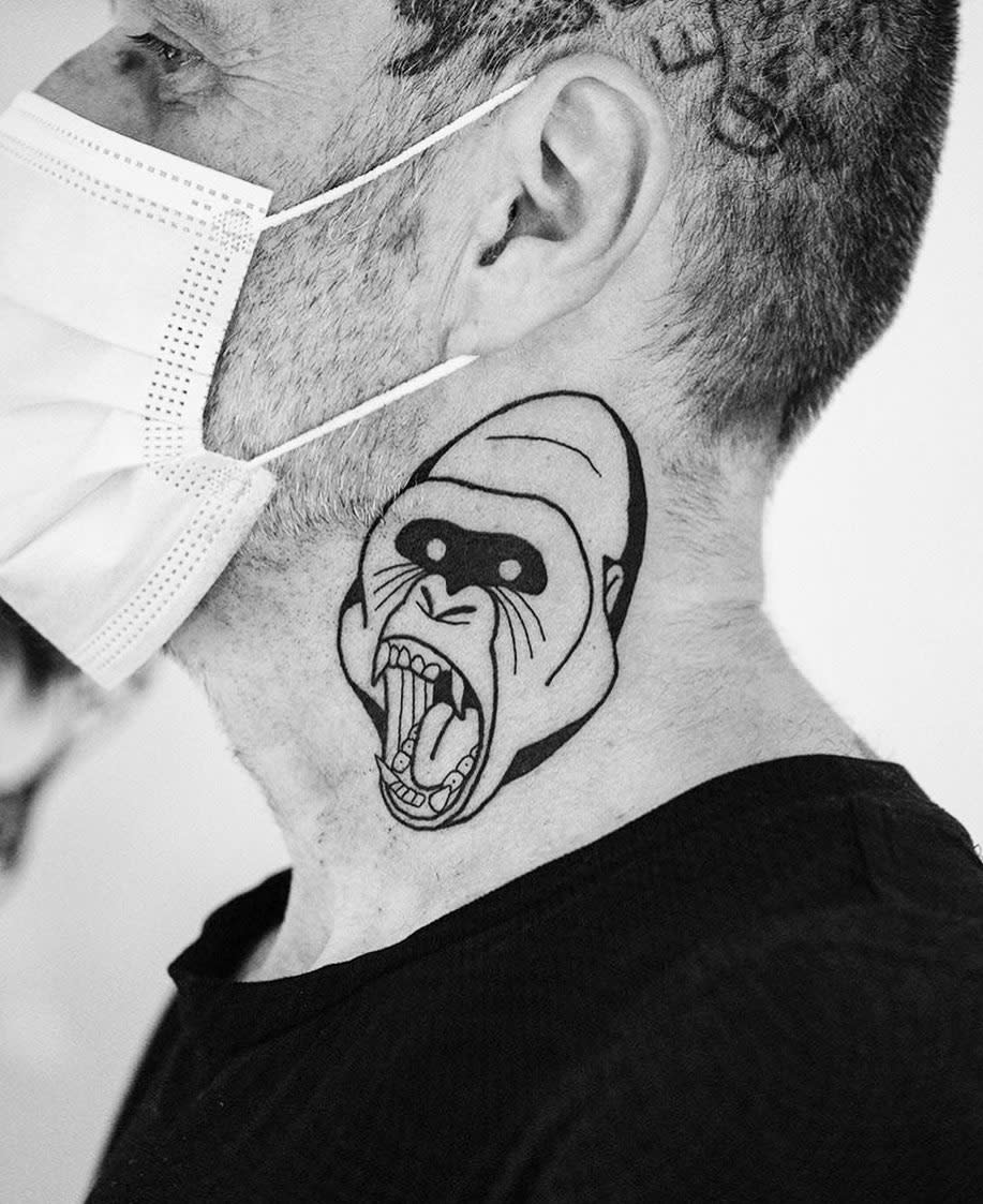 Black gorilla head tattoo on neck