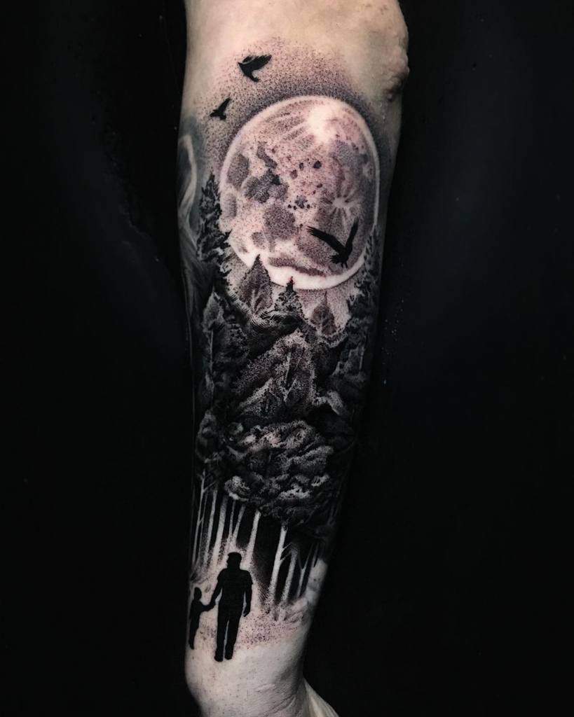 Tattoo of a forest scene with a moon, birds, and two silhouettes walking