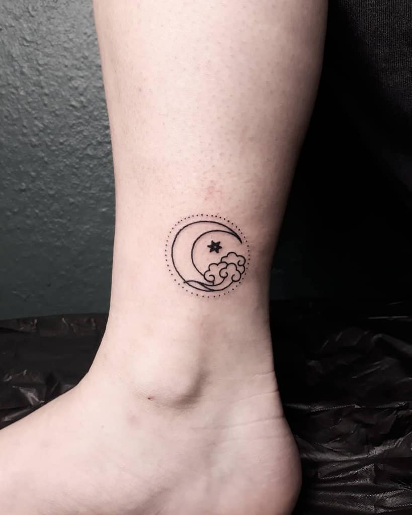 Line art tattoo of a moon, stars, and wave on an ankle