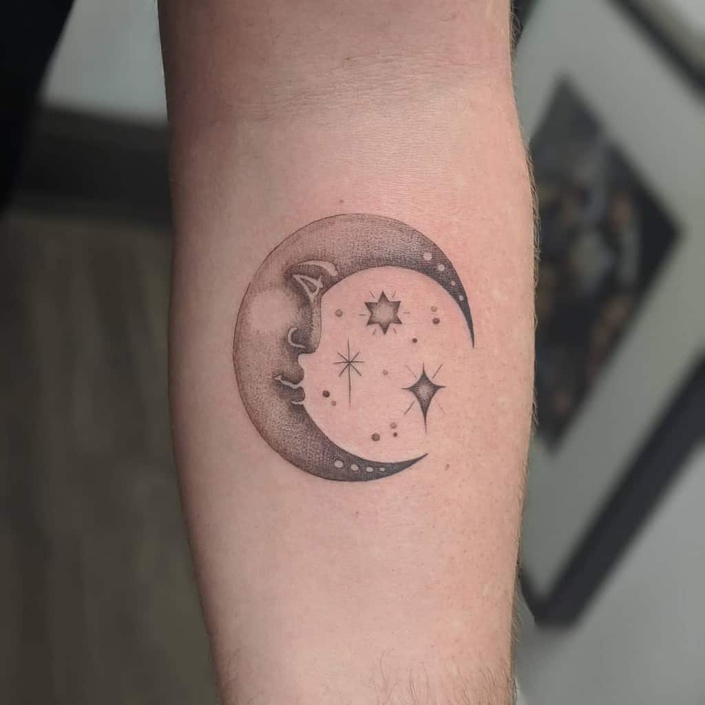 Forearm tattoo of a crescent moon with a face surrounded by stars and smaller circles