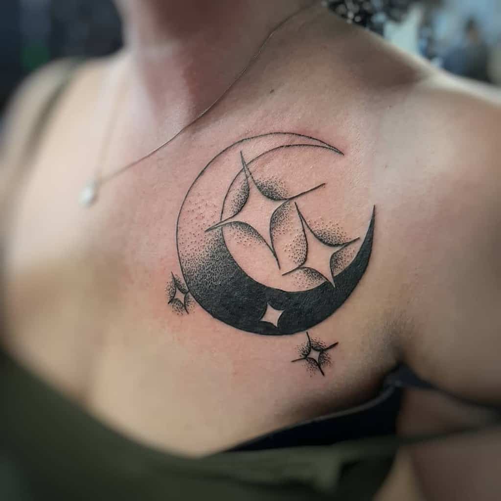 Black crescent moon tattoo with stars on the upper chest